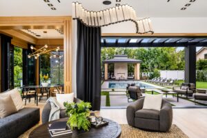 ambient lighting for living rooms provided by a contemporary chandelier, and greenery.