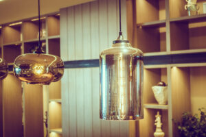 Close-up of modern hanging light fixtures in a room with wooden shelves