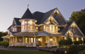 A large, two-story stone house becomes the perfect canvas for luxury home lighting ideas